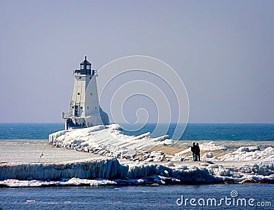 Ludington`s North Breakwater Light in Mason County, Michigan Lighthouse in the Winter with sightseers. Stock Photo