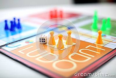 Ludo board game with different colored pawns Editorial Stock Photo