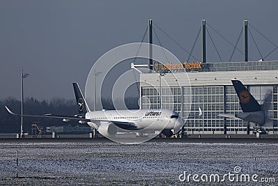 Lufthansa Airbus plane taxiing on runway, snow Editorial Stock Photo