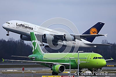Lufthansa A380 plane taking off, S7 plane taxiing Editorial Stock Photo