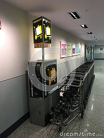 Luggage carts at the Arrivals terminal at Tucson International Airport Editorial Stock Photo