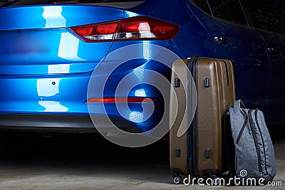 Luggage stand next to closed car trunk Stock Photo