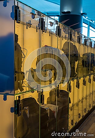 Luggage stored in transparent glass boxes in airport lounge Stock Photo