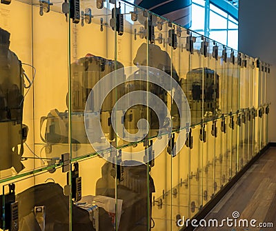 Luggage stored in transparent glass boxes in airport lounge Stock Photo