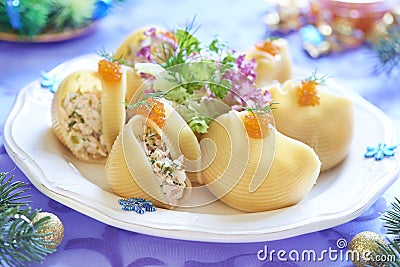 Lumaconi pasta with seafood salad, red caviar and fennel Stock Photo