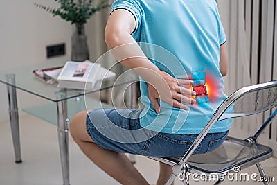 Lumbar intervertebral spine hernia, man with back pain at home, spinal disc disease Stock Photo