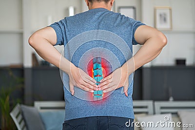 Lumbar intervertebral spine hernia, man with back pain at home, spinal disc disease Stock Photo
