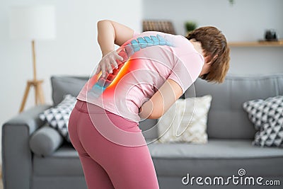 Lumbar intervertebral spine hernia, woman with back pain at home, spinal disc disease Stock Photo