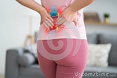 Lumbar intervertebral spine hernia, woman with back pain at home, spinal disc disease Stock Photo