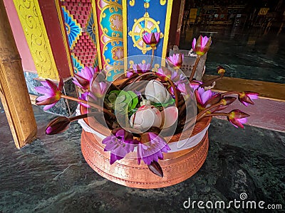Colorful bouquet of flowers in a clay vase in the entrance of the buddhist temple. Editorial Stock Photo