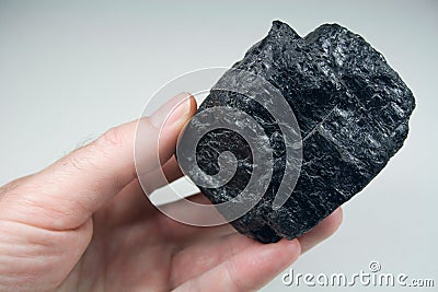 Lump of Raw Coal in Hand Stock Photo