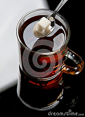 Lump sugar in tea Stock Photo