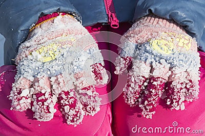 Lumps of frozen snow on woolen gloves Stock Photo