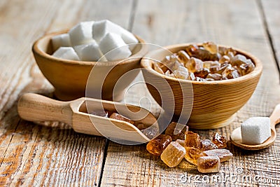 Lumps of white and brown sugar on wooden table background Stock Photo