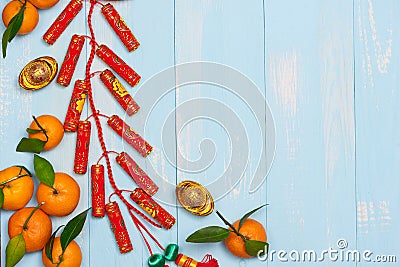Lunar new year.Firecrackers and Chinese gold ingots and Traditional Red envelopes and decoration with Fresh oranges on wooden Stock Photo