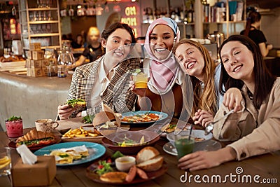 Lunch. Group Of Women In Cafe Portrait. Smiling Multicultural Girls With Cocktails. Stock Photo