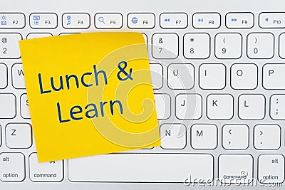 Lunch and Learn message on yellow sticky note on a gray keyboard Stock Photo