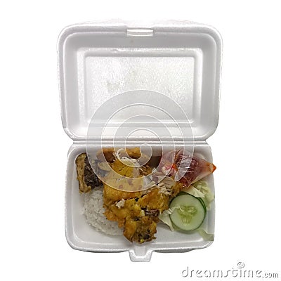 Lunch of rice with fried chicken called ayam penyet on a styrofoam container Stock Photo