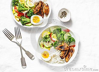 Lunch served - stewed vegetables, rice, boiled egg and teriyaki chicken on light background Stock Photo