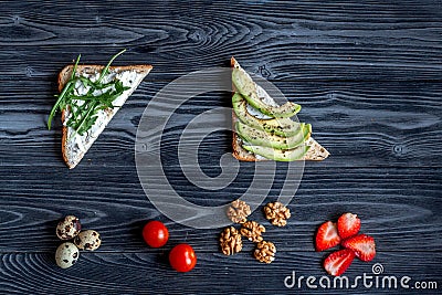 Lunch with triangle sandwiches on dark table background top view Stock Photo