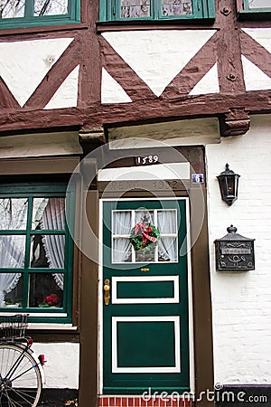 Luneburg, Germany - 10.12.2017: Traditional facades of medieval houses. Decorated for Christmas doors and windows Editorial Stock Photo