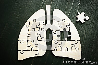 Lung cancer or respiratory disease concept. Wooden puzzle on the surface. Stock Photo