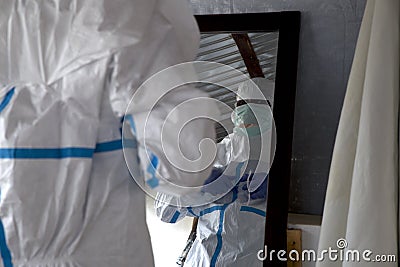 Lunsar, Sierra Leone - April 29th, 2015: African health worker getting ready and putting on EPP protective clothes during the Editorial Stock Photo