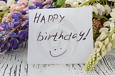 Lupine flowers with message card on a old wooden table Stock Photo