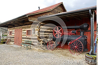 Steam Engine and Log Cabin at Luray Valley Museum. Luray, VA, USA. April 10, 2015. Editorial Stock Photo