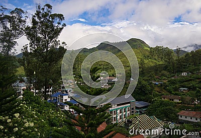 Lush green trees on the background of the Munnar town and rolling hills Editorial Stock Photo