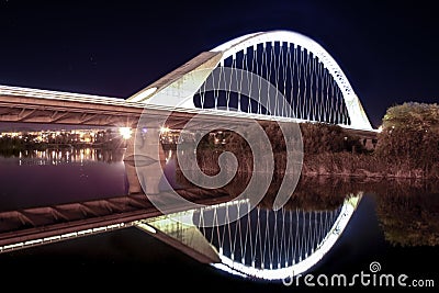 Lusitania bridge over Guadiana River at night Stock Photo