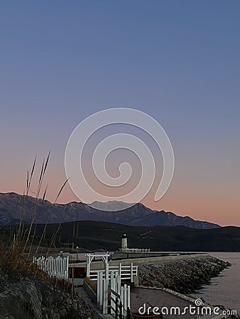Lustica Bay lighthouse at sunset Stock Photo