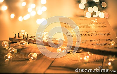 Lute with instrumental sheet music and soft lights for Christmas holiday, split tone Stock Photo