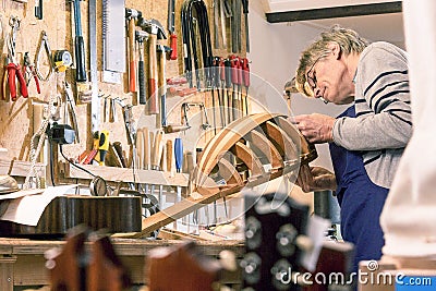 Luthier inspecting his halfway finished lute Stock Photo