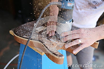 Luthier Using Power Tool to Build Handmade Wooden Electric Guitar Stock Photo