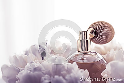 Luxe fragrance bottle as vintage perfume product on violet background and peony flowers, parfum ad and beauty branding Stock Photo