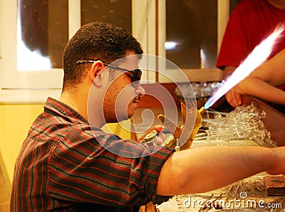 Luxor / Egypt, Africa - 9 May, 2008: Egyptian glass blower makes a demostration of making a bottle of perfume. Editorial Stock Photo