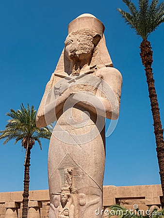 Luxor, Egypt - October 3, 2021: View of the statue of Ramses II in the Karnak temple against the background of the blue sky and Editorial Stock Photo