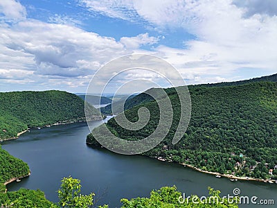 luxuriant landscape of a lake surrounded by thick forest incredible aerial view in Romania Transylvania Stock Photo