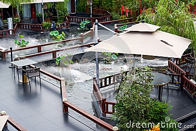 Luxurious Chinese garden restaurant seats and ancient building turret Stock Photo