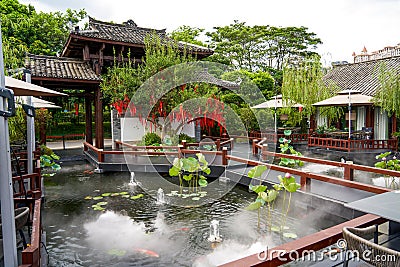 Luxurious Chinese garden restaurant seats and ancient building turret Stock Photo