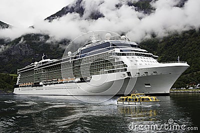 A luxurious cruise ship anchored near a Norwegian fjord village Flam during the summer months Editorial Stock Photo