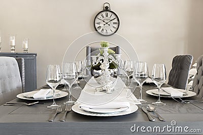 A luxurious dining room of a house with glasses and plates Stock Photo