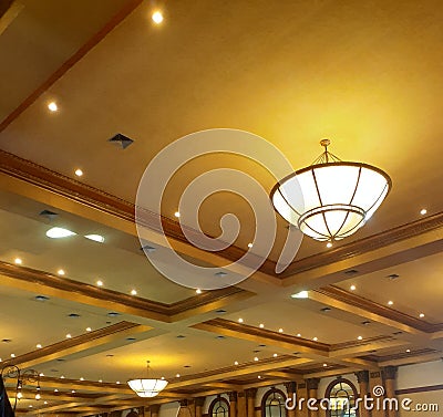 Luxurious gold color ceiling with some artistic lamps Stock Photo