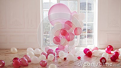 Luxurious living room with large window to the floor. Palace is filled with pink balloons Stock Photo