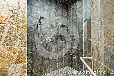 Luxurious mansion walk-in shower with black square tiled walls Stock Photo