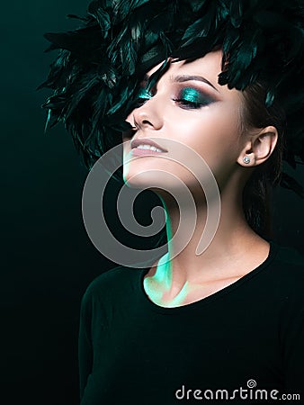 Luxurious mystical portrait, femme fatale in green. Portrait of a beautiful young girl Stock Photo