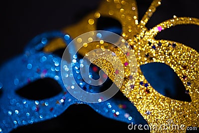 Luxurious Venetian shiny masks on a dark background. Carnival masquerade fantasy mask. Holiday and party concept. Blurred photo Stock Photo