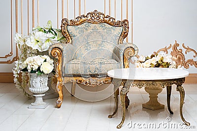 Luxurious vintage interior in the aristocratic style with elegant armchair and flowers. Retro, classics. Stock Photo