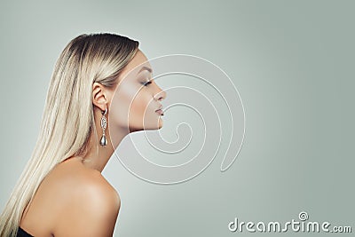 Luxurious Woman with Healthy Blonde Hairstyle, and Black Pearls Earrings on Background with Copy space, Profile Stock Photo